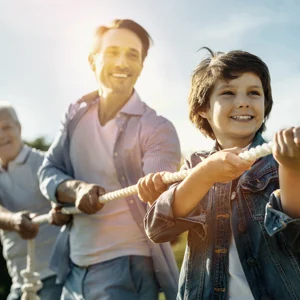 Team of people holding a rope