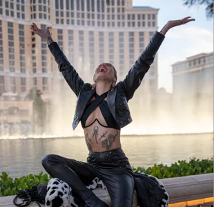 A person sitting in front of the fountains at the Bellagio hotel