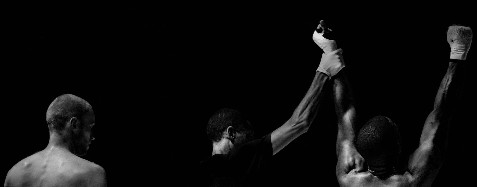 A referee holding up a fighters arm