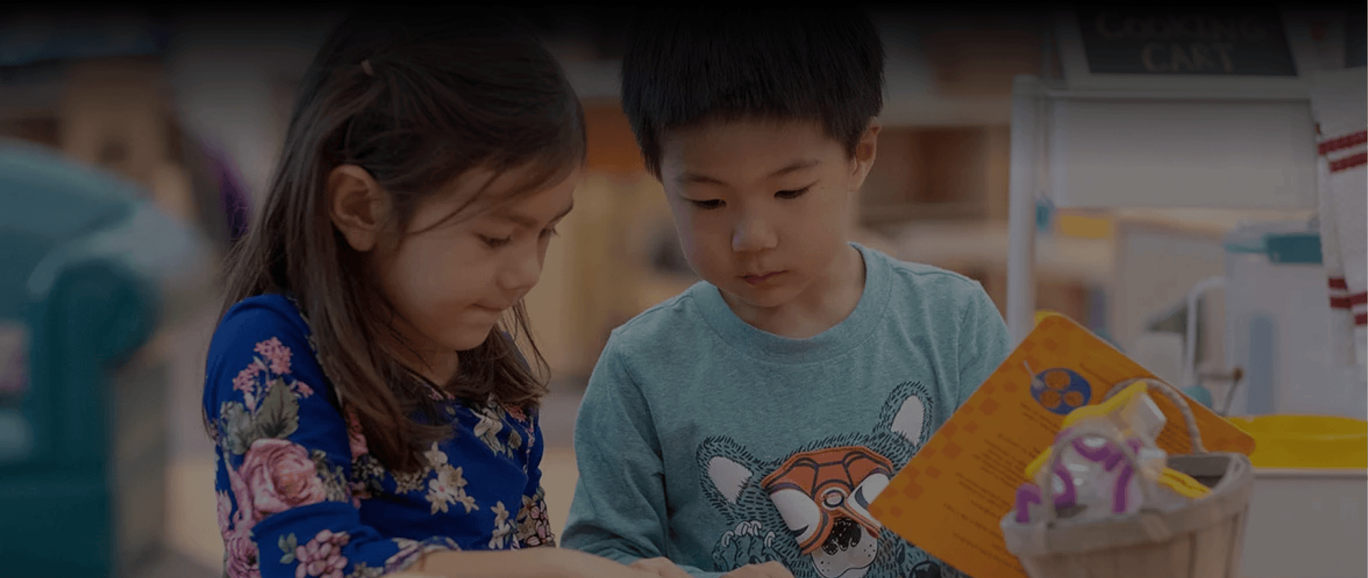 Two children looking at a book