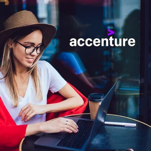 A person sitting at a table in front of a laptop