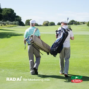 Two people walking down a fairway holding golf bags